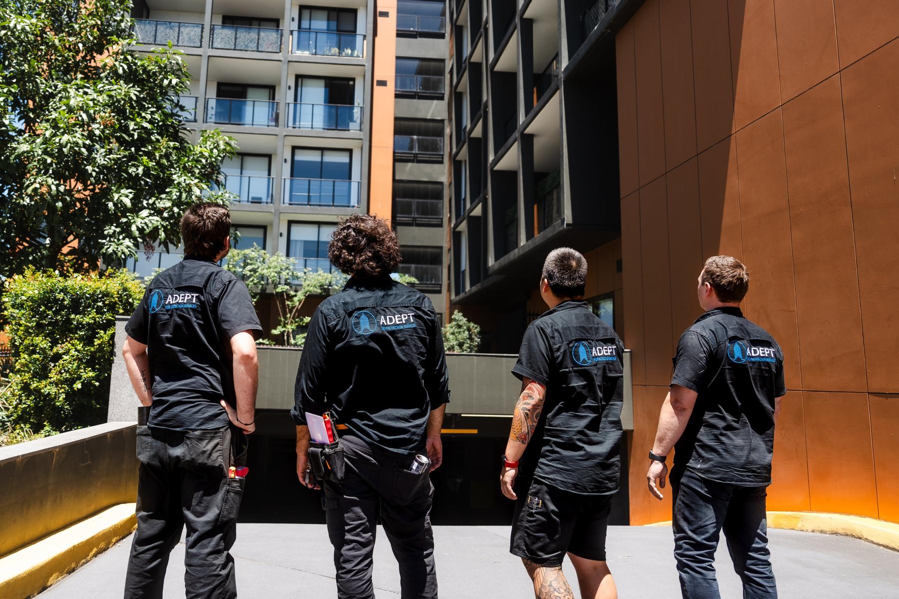 Adept technicians inspecting a building